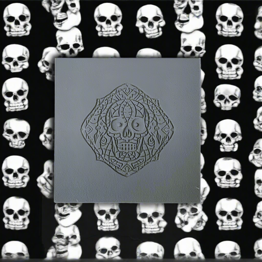 A texture tile with a debossed skull. Use to make embossed impressions on metal clay such as Art Clay Silver and polymer clay.