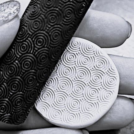 Close-up of black and white textured swirls held in hands