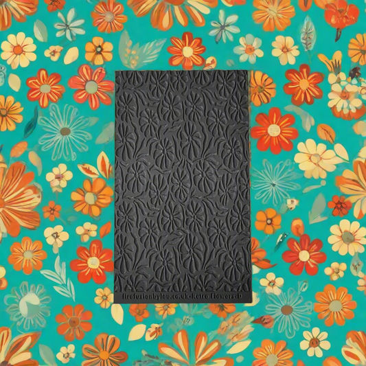 A texture tile with a debossed retro flowers pattern. Use to make embossed impressions on metal clay such as Art Clay Silver and polymer clay.