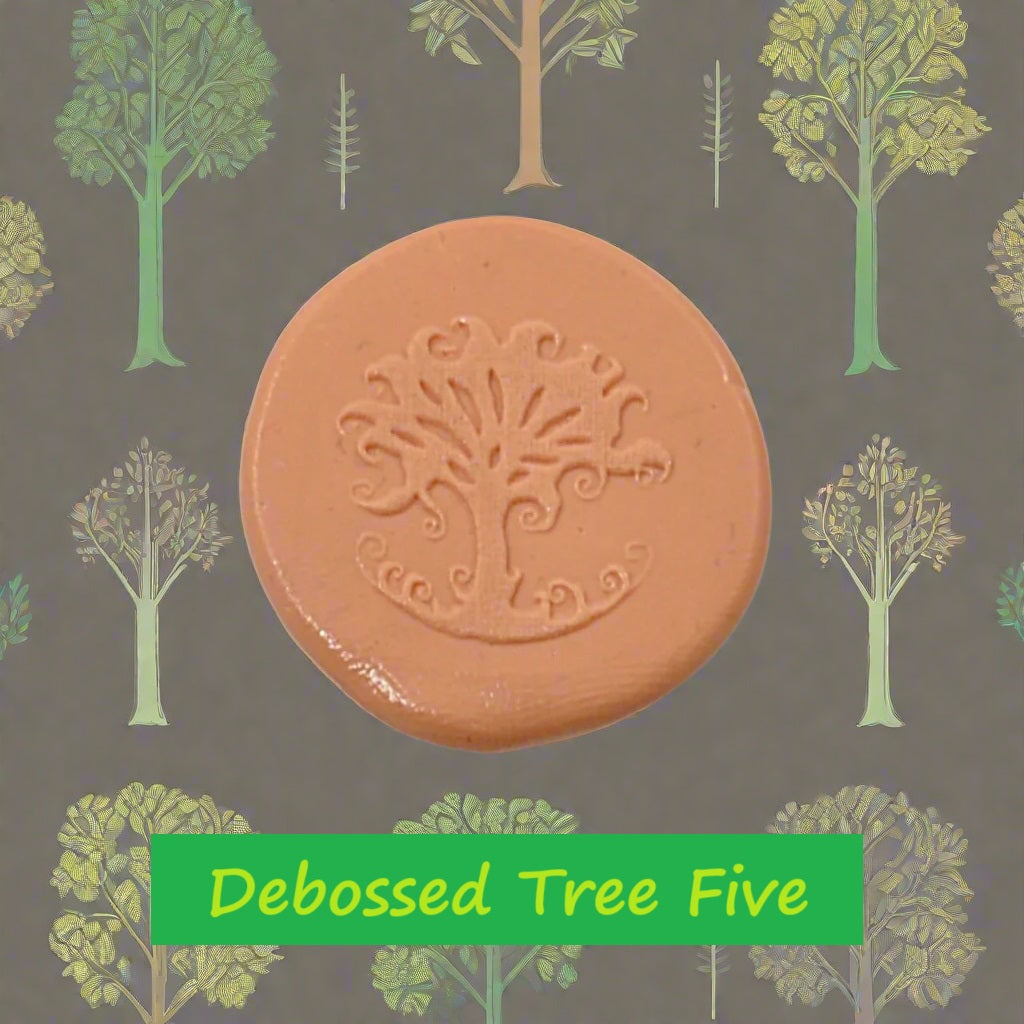 A tree embossed in silly putty Using a debossed texture mat in grey material. This will give you an idea of what it will look like on metal clay or polymer clay.