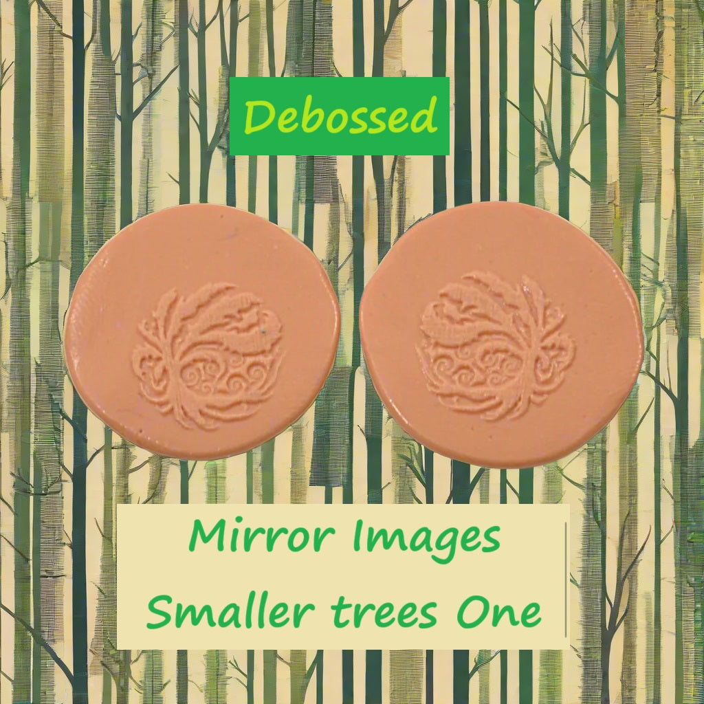 A tree embossed in silly putty Using a debossed texture mat in grey material. This will give you an idea of what it will look like on metal clay or polymer clay.