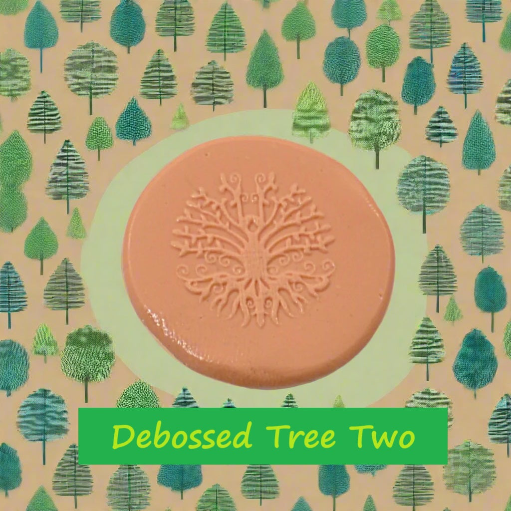A tree embossed in silly putty Using a debossed texture mat in grey material. This will give you an idea of what it will look like on metal clay or polymer clay.