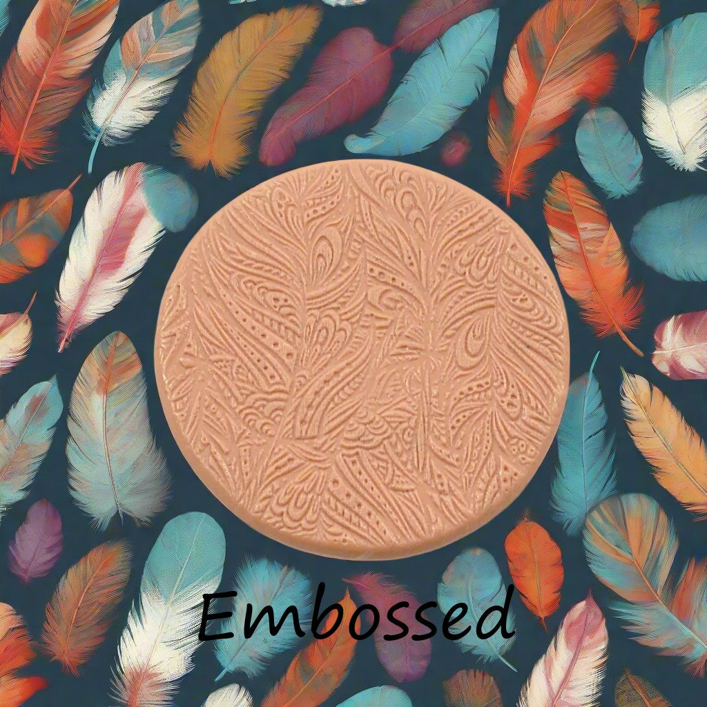 A tribal psychedelic feather pattern debossed in silly putty Using a patterned embossed texture mat in grey material. This will give you an idea of what it will look like on metal clay or polymer clay.