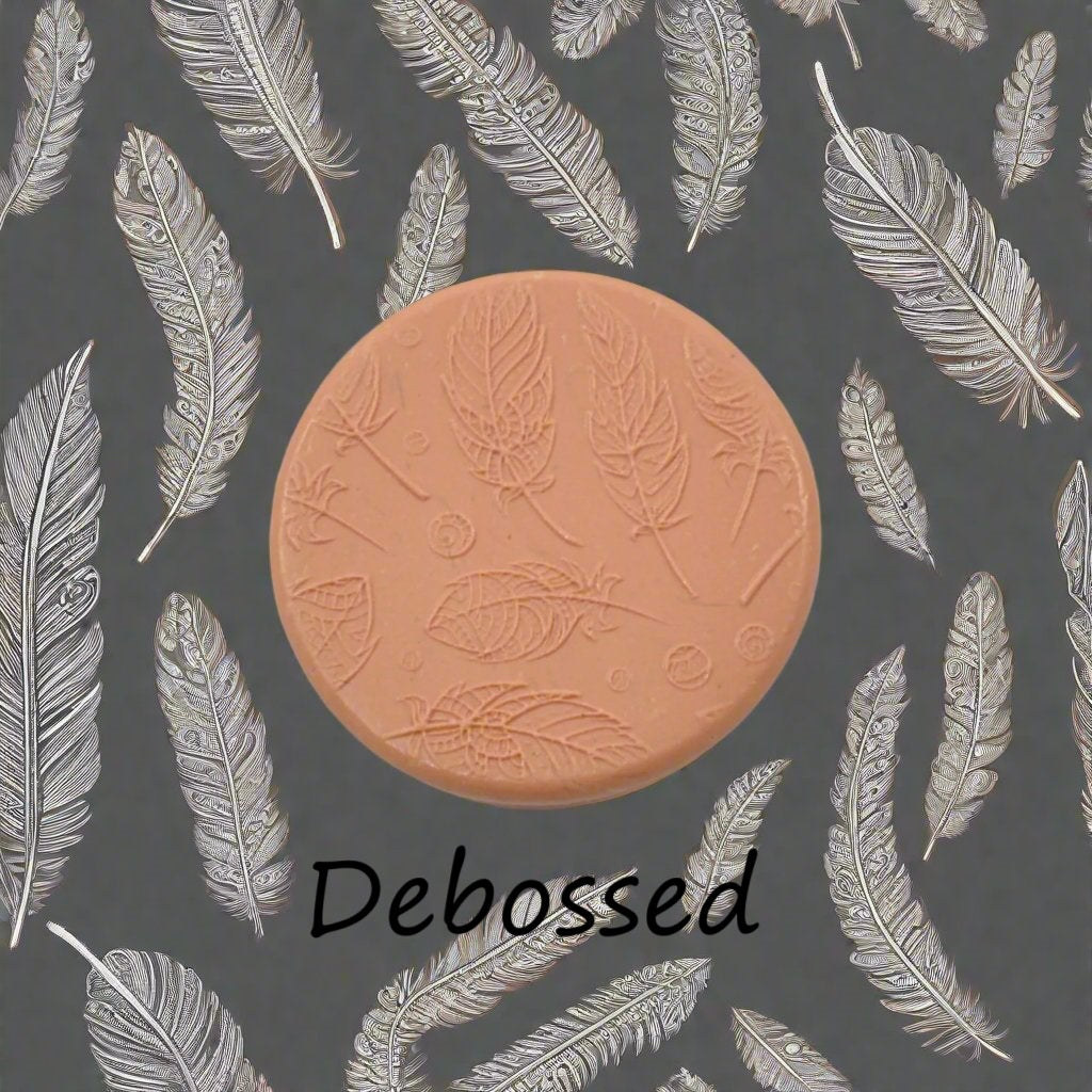 A tribal feather pattern embossed in silly putty Using a patterned debossed texture mat in grey material. This will give you an idea of what it will look like on metal clay or polymer clay.