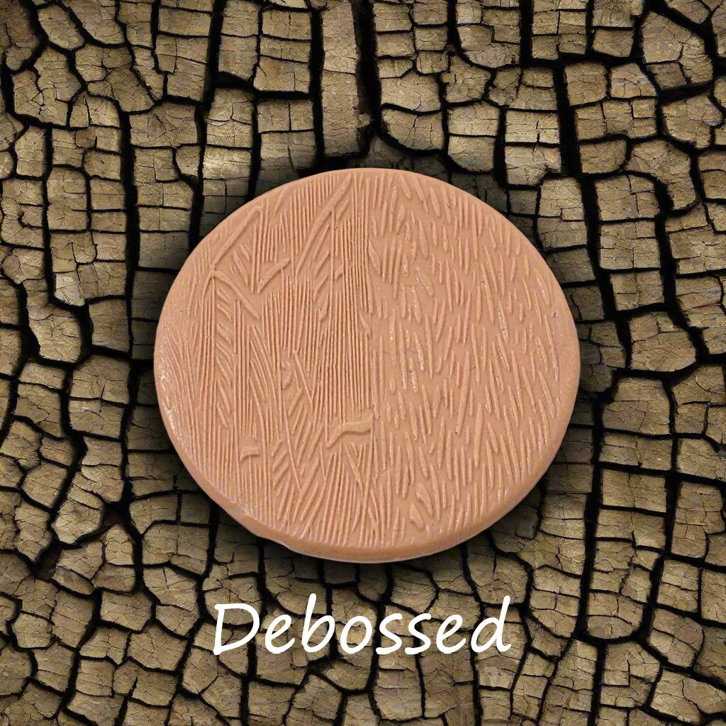 Tree bark designs embossed in silly putty Using a debossed texture mat. This will give you an idea of what it will look like on metal clay or polymer clay.