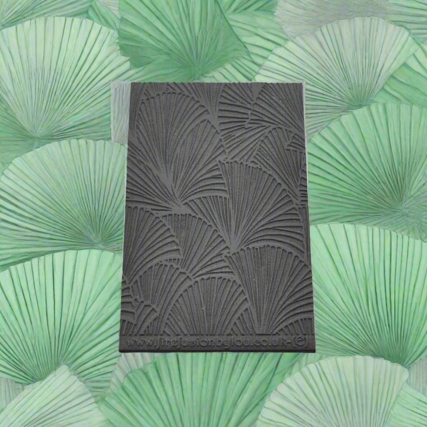 A 95 x 55 mm embossed texture mat with fan leaves. Use to make a embossed impression on metal clay and polymer clay.
