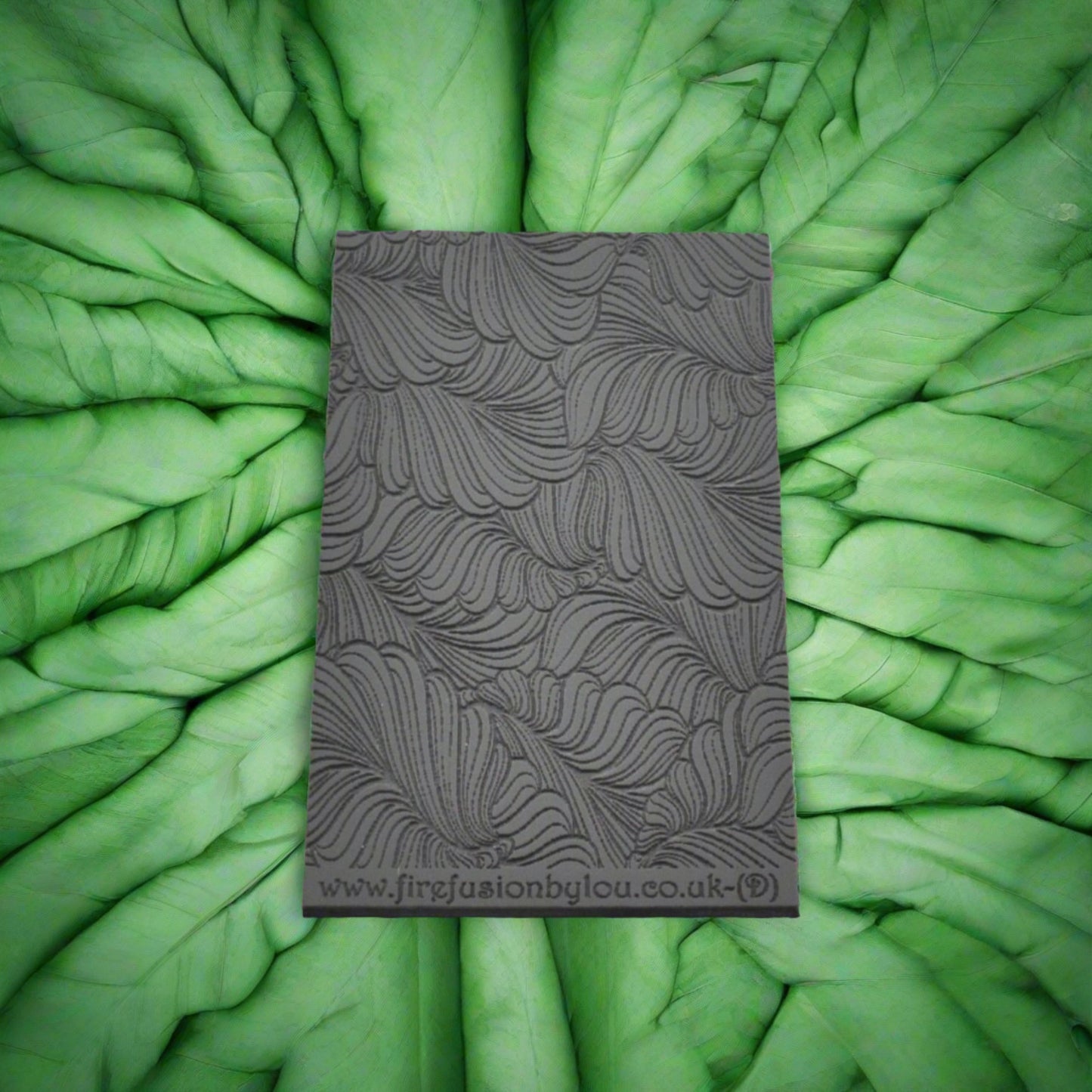 A 95 x 55 mm debossed texture mat with curly leaves. Use to make a embossed impression on metal clay and polymer clay.