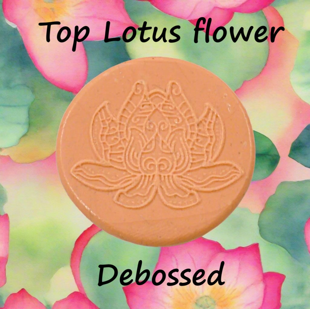 A lotus flower mandala embossed in silly putty Using a debossed texture mat in grey material. This will give you an idea of what it will look like on metal clay or polymer clay.