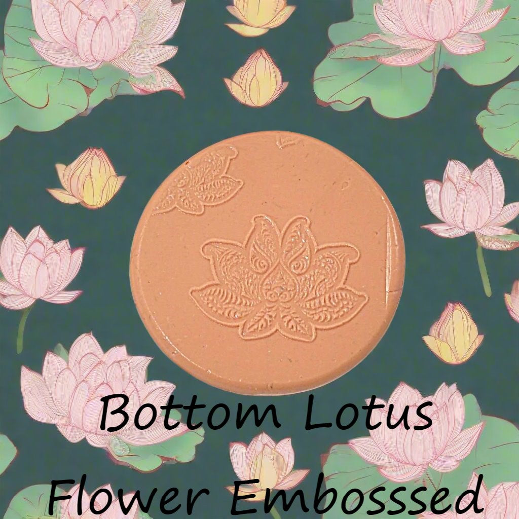 A lotus flower mandala debossed in silly putty Using a embossed texture mat in grey material. This will give you an idea of what it will look like on metal clay or polymer clay.