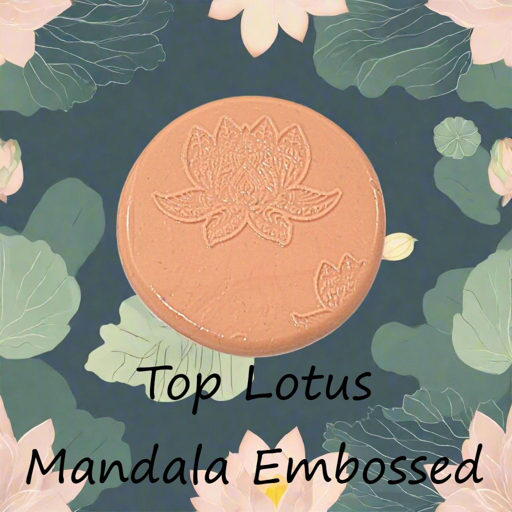 A lotus flower mandala debossed in silly putty Using a embossed texture mat in grey material. This will give you an idea of what it will look like on metal clay or polymer clay.