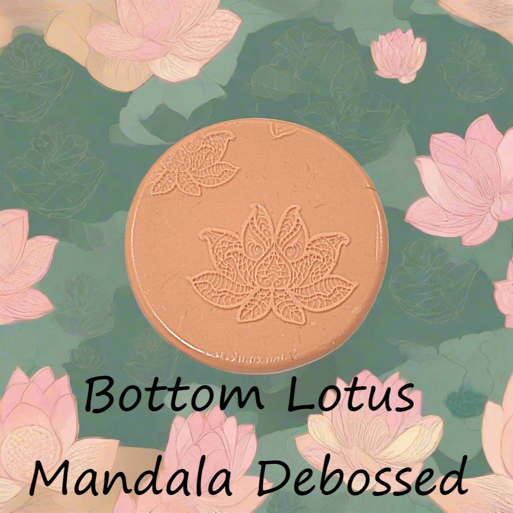 A lotus flower mandala embossed in silly putty Using a debossed texture mat in grey material. This will give you an idea of what it will look like on metal clay or polymer clay.