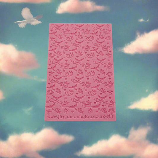 A lovebird pattern debossed texture mat. This texture mat will give you an embossed effect on metal clay or polymer clay.