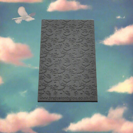 A lovebird pattern debossed texture mat in grey material. This texture mat will give you an embossed effect on metal clay or polymer clay.