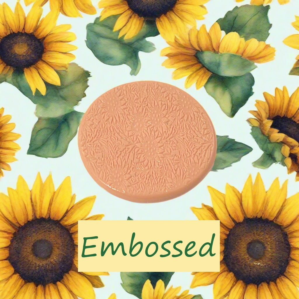 A small sunflower pattern debossed in silly putty Using a small sunflower patterned embossed texture mat in grey material. This will give you an idea of what it will look like on metal clay or polymer clay.
