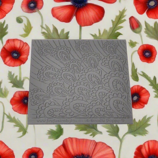 A pattern debossed texture mat in grey material. This texture mat will give you an embossed effect on metal clay or polymer clay.