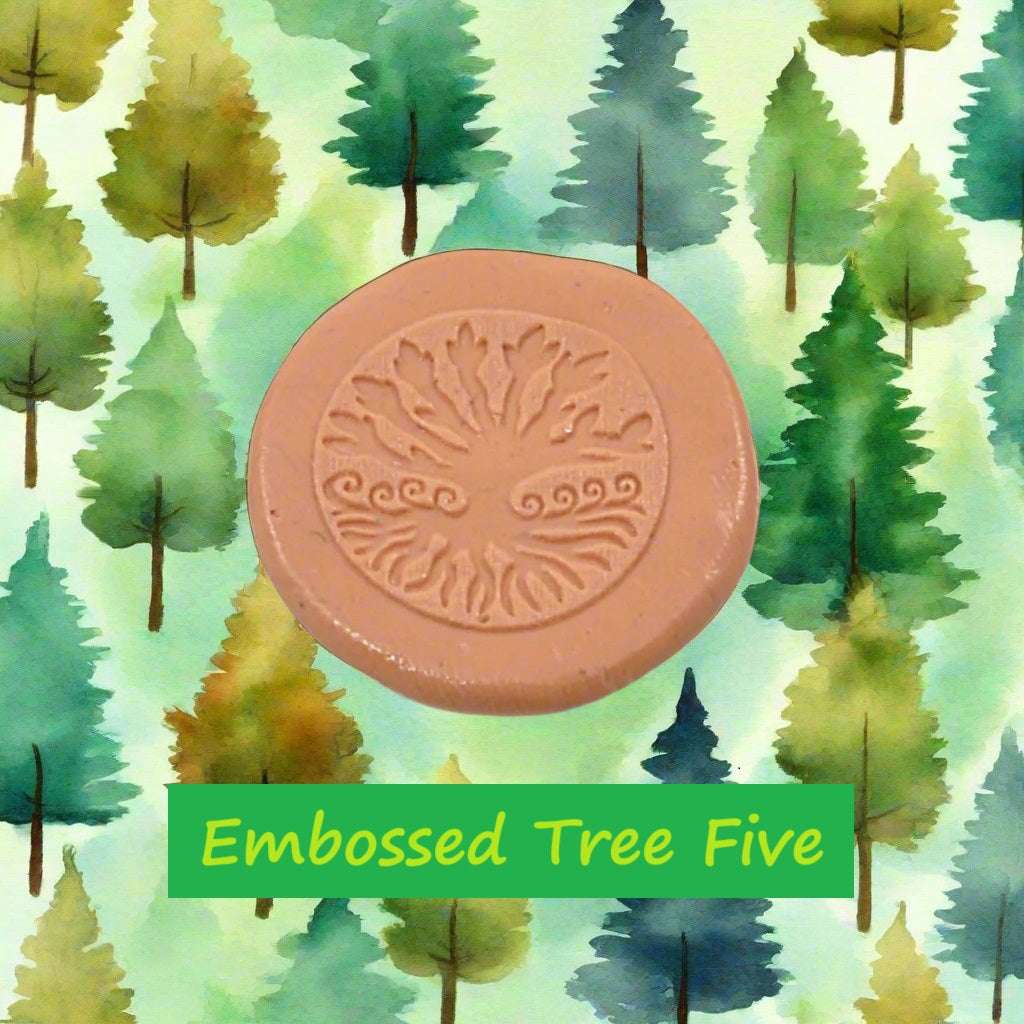 A tree debossed in silly putty Using a embossed texture mat in grey material. This will give you an idea of what it will look like on metal clay or polymer clay