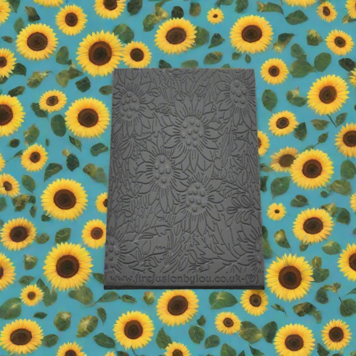 A large sunflower pattern debossed texture mat in grey material. This texture mat will give you an embossed effect on metal clay or polymer clay.