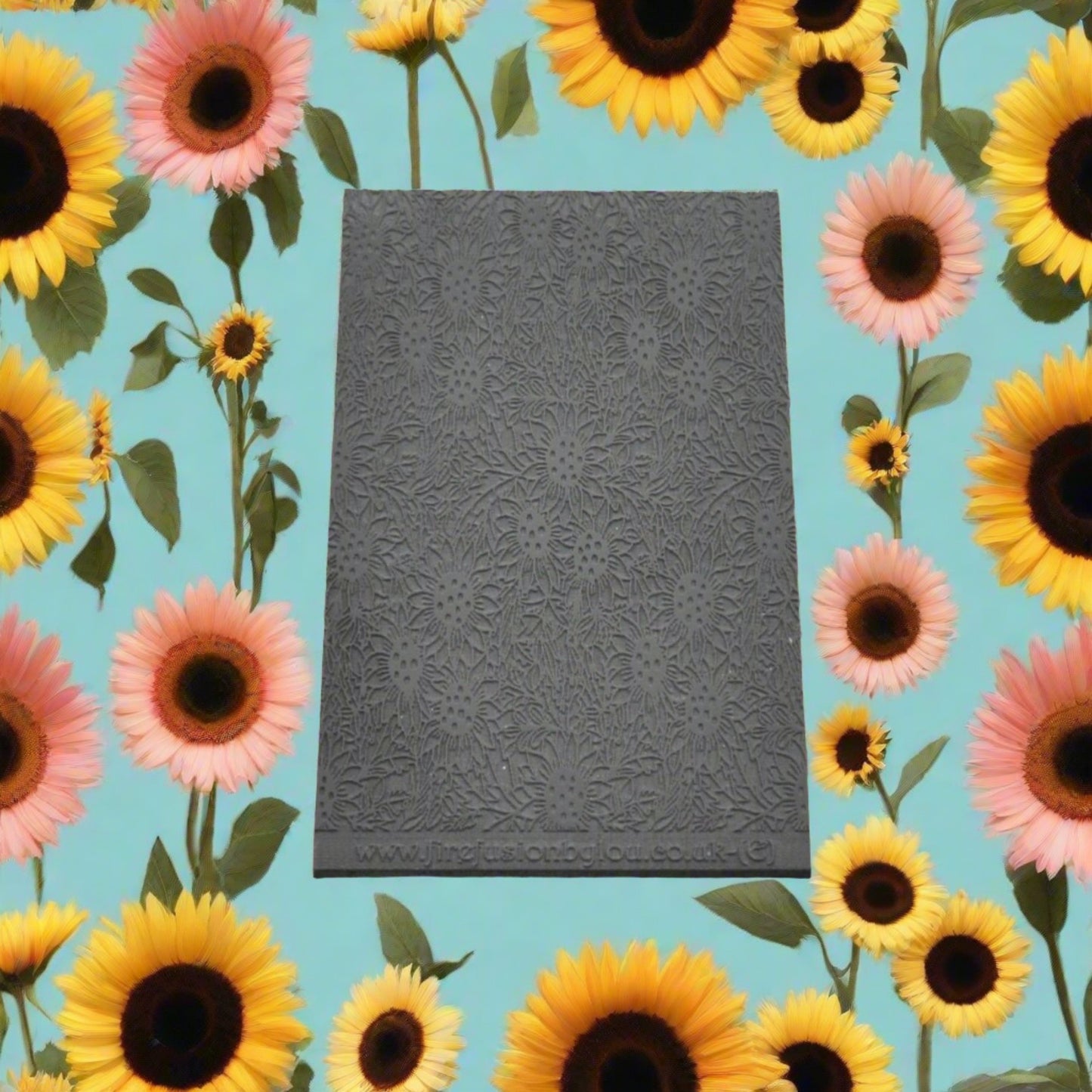 A small sunflower pattern embossed texture mat in grey material. This texture mat will give you a debossed effect on metal clay or polymer clay.