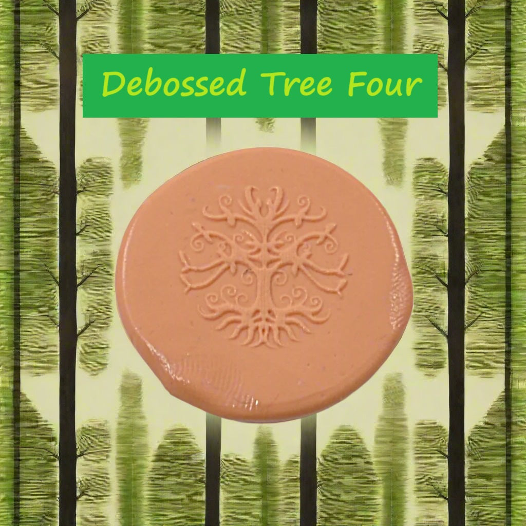 A tree embossed in silly putty Using a debossed texture mat in grey material. This will give you an idea of what it will look like on metal clay or polymer clay.