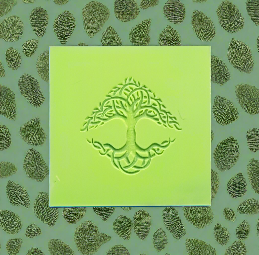 Green square rubber with embossed tree design on a green leaf-patterned background