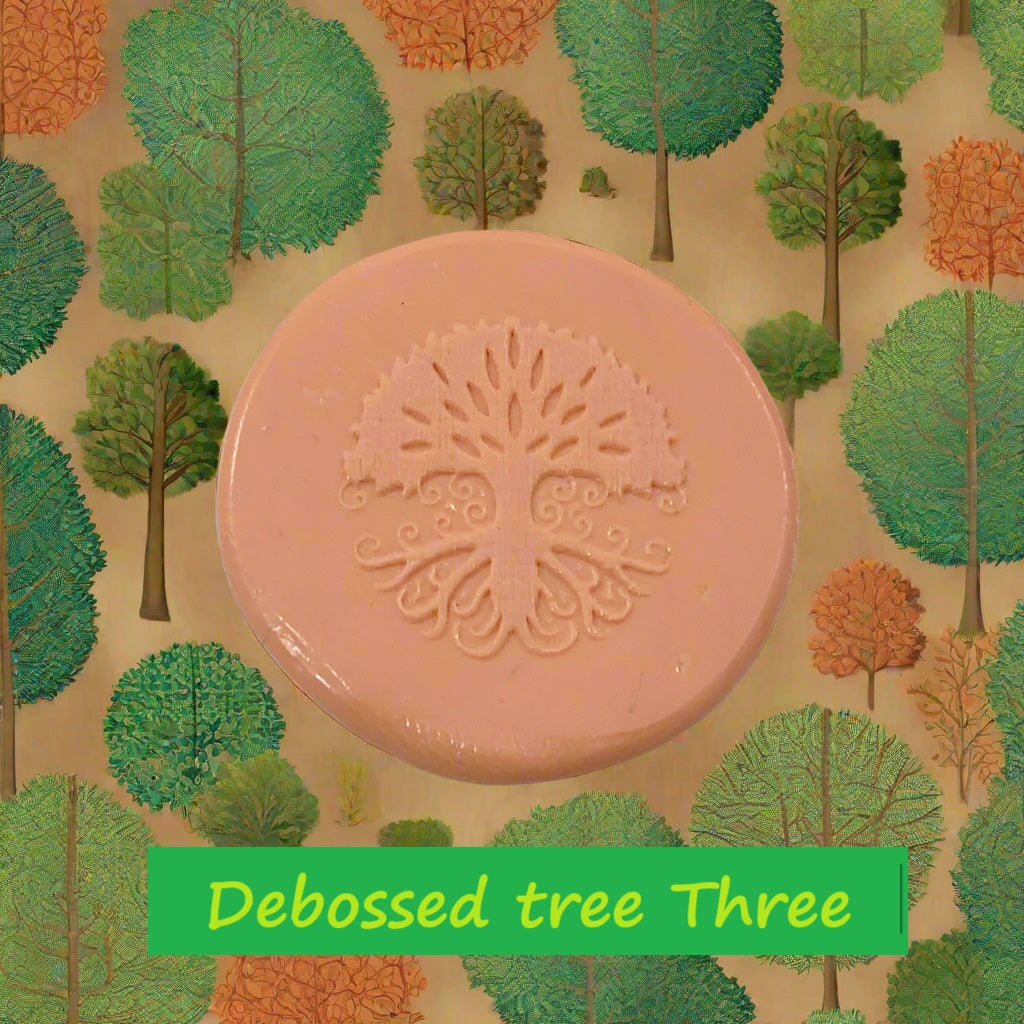 A tree embossed in silly putty Using a debossed texture mat in grey material. This will give you an idea of what it will look like on metal clay or polymer clay.