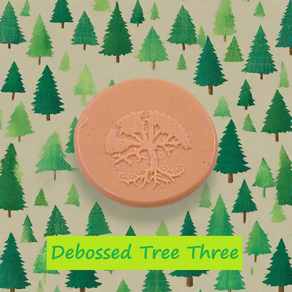 A tree embossed in silly putty Using a debossed texture mat in grey material. This will give you an idea of what it will look like on metal clay or polymer clay