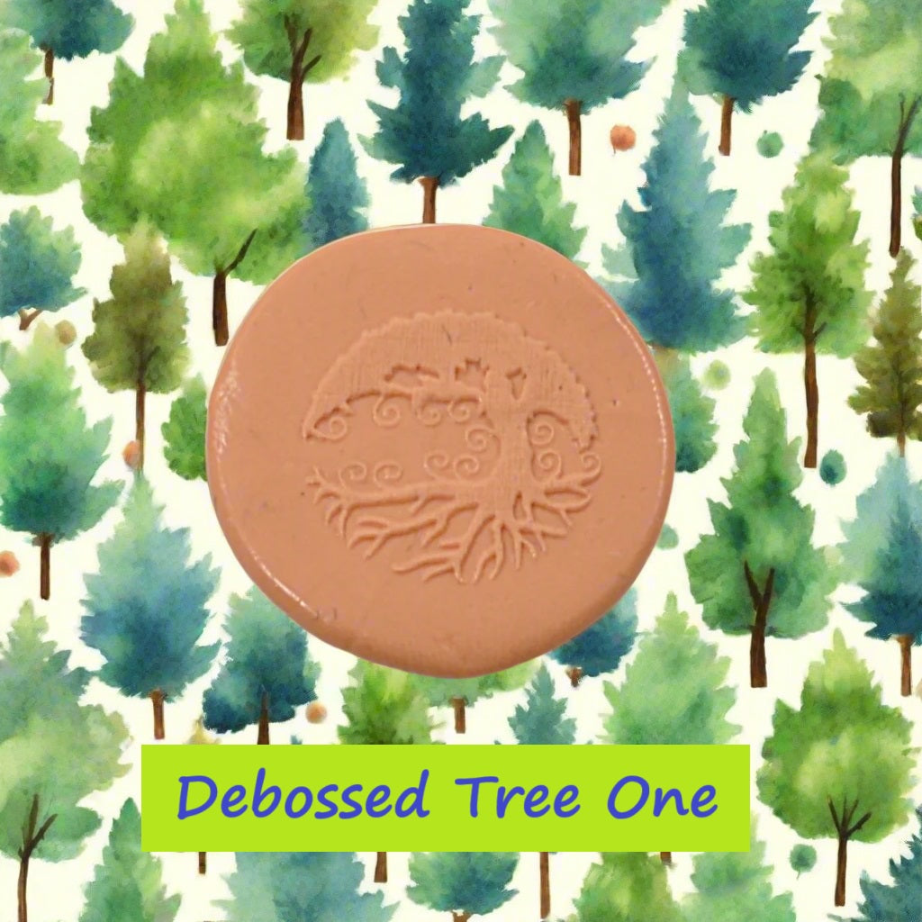 A tree embossed in silly putty Using a debossed texture mat in grey material. This will give you an idea of what it will look like on metal clay or polymer clay.