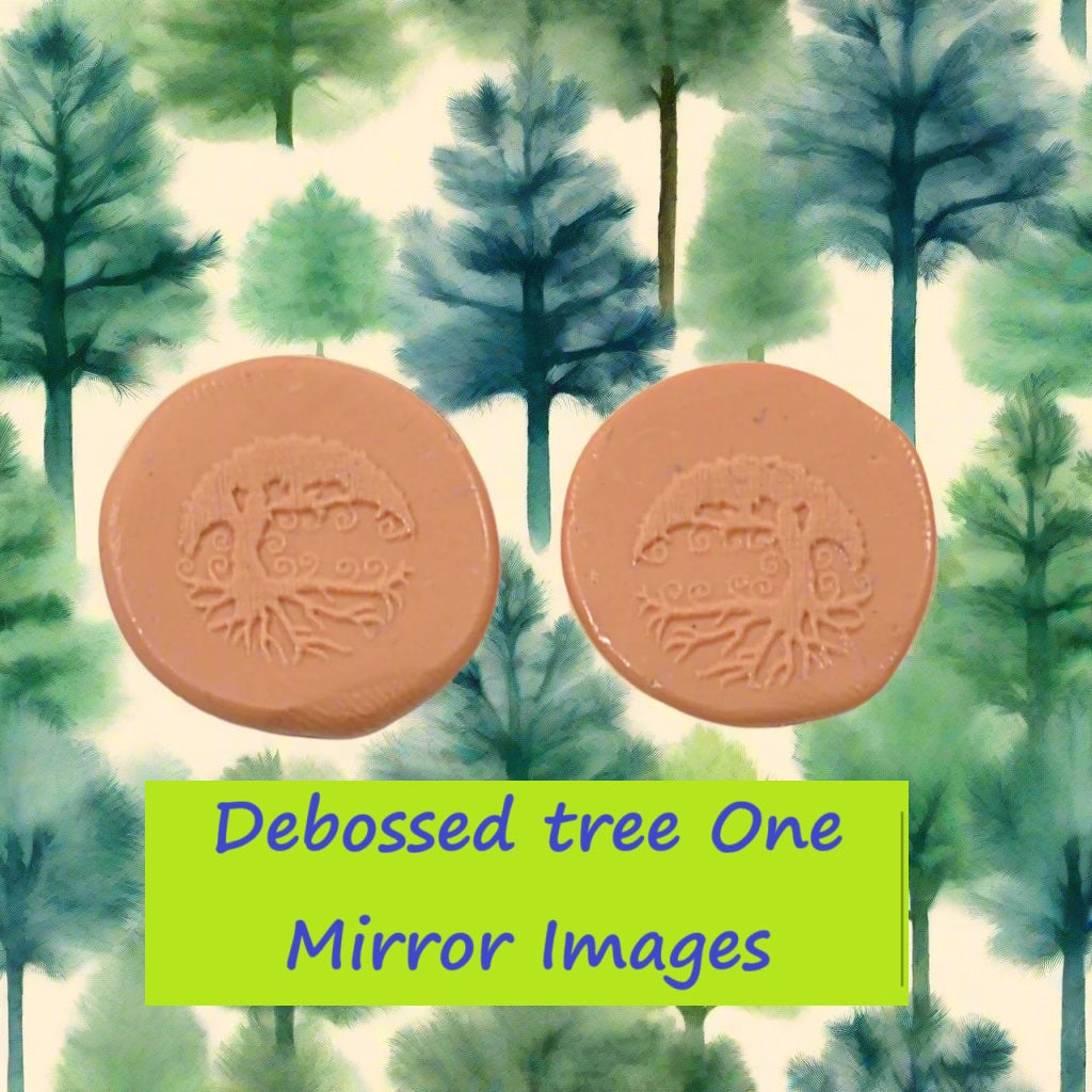 A tree embossed in silly putty Using a debossed texture mat in grey material. This will give you an idea of what it will look like on metal clay or polymer clay.