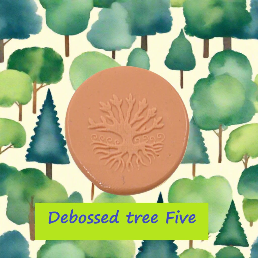 A tree embossed in silly putty Using a debossed texture mat in grey material. This will give you an idea of what it will look like on metal clay or polymer clay.
