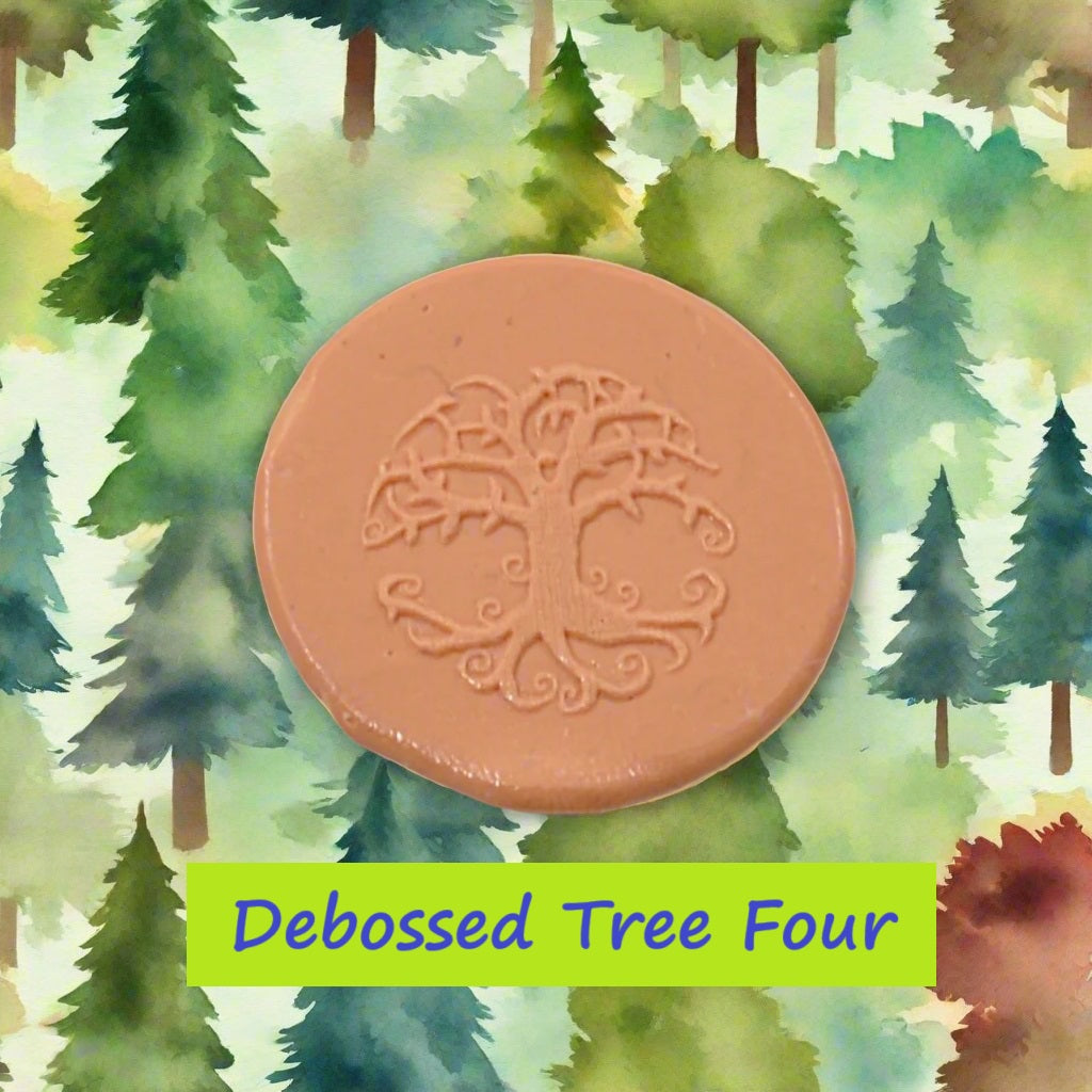 A tree embossed in silly putty Using a debossed texture mat in grey material. This will give you an idea of what it will look like on metal clay or polymer clay.