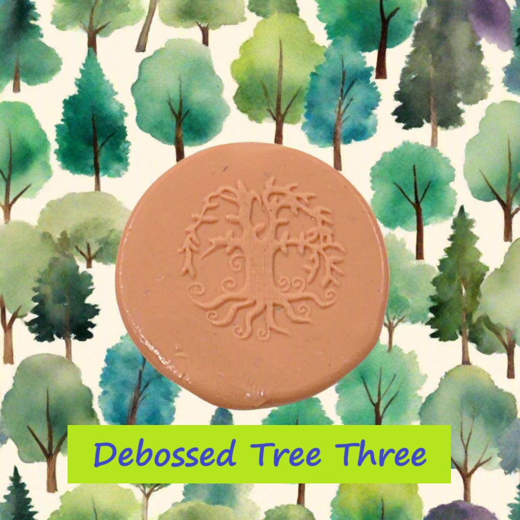 A tree embossed in silly putty Using a debossed texture mat in grey material. This will give you an idea of what it will look like on metal clay or polymer clay.