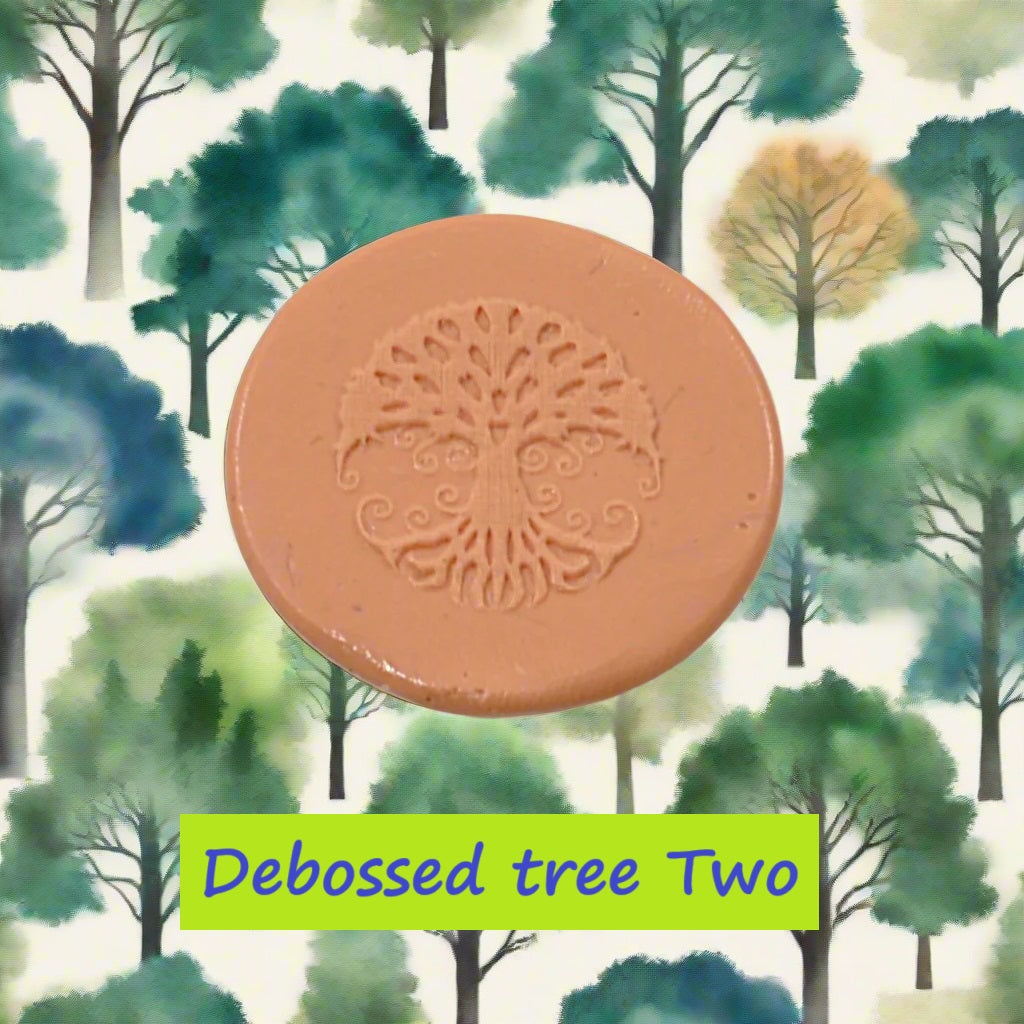 A tree embossed in silly putty Using a debossed texture mat in grey material. This will give you an idea of what it will look like on metal clay or polymer clay.