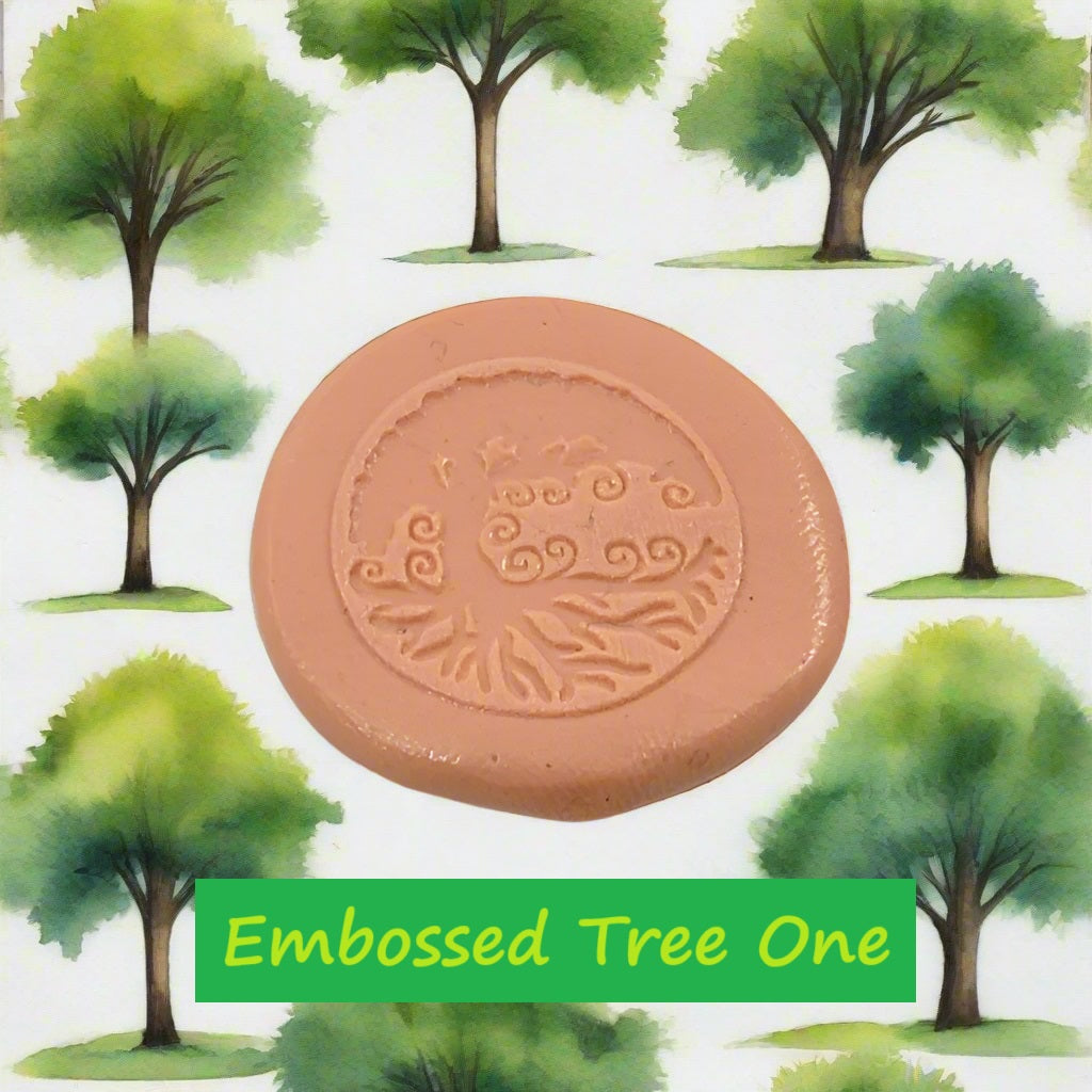 A tree debossed in silly putty Using a embossed texture mat in grey material. This will give you an idea of what it will look like on metal clay or polymer clay.