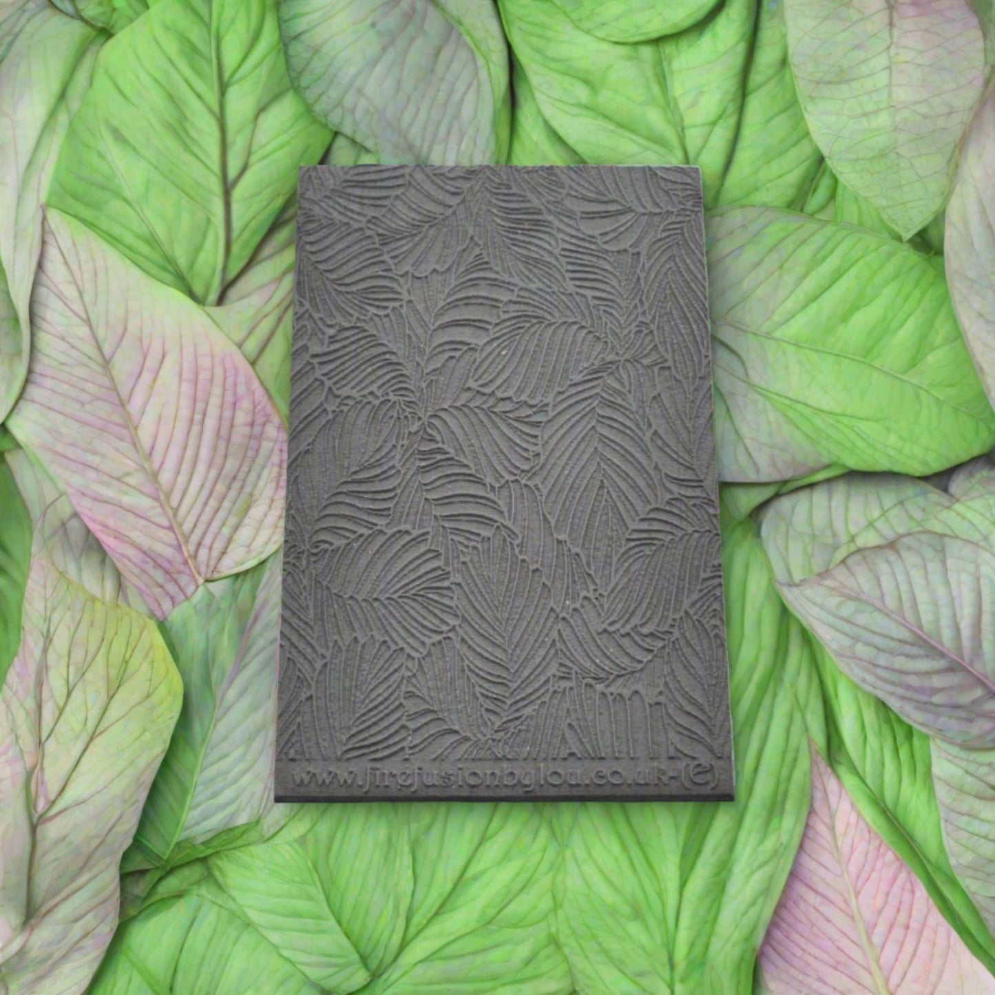 A 95 x 55 mm embossed texture mat with variegated leaves. Use to make a embossed impression on metal clay and polymer clay.