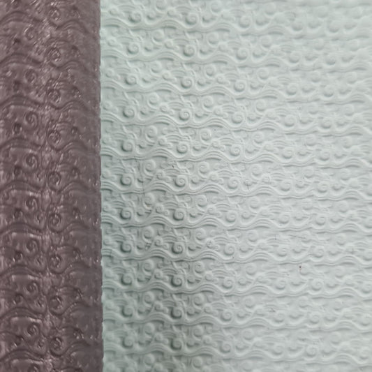 Two textured one brown roller and white wave in clay.