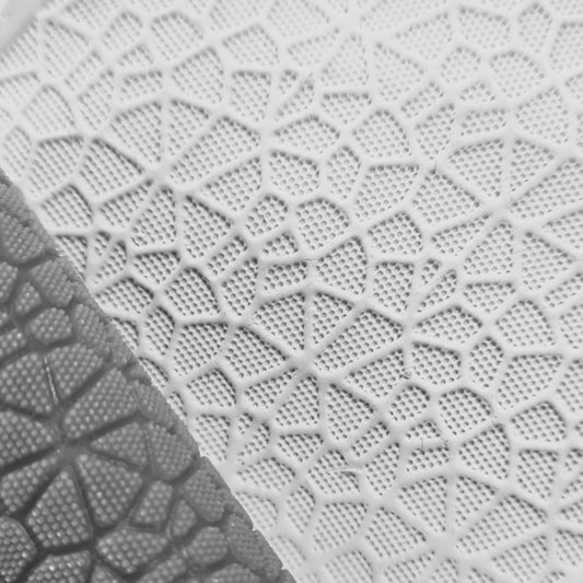 Close-up of textured white surface with geometric pattern