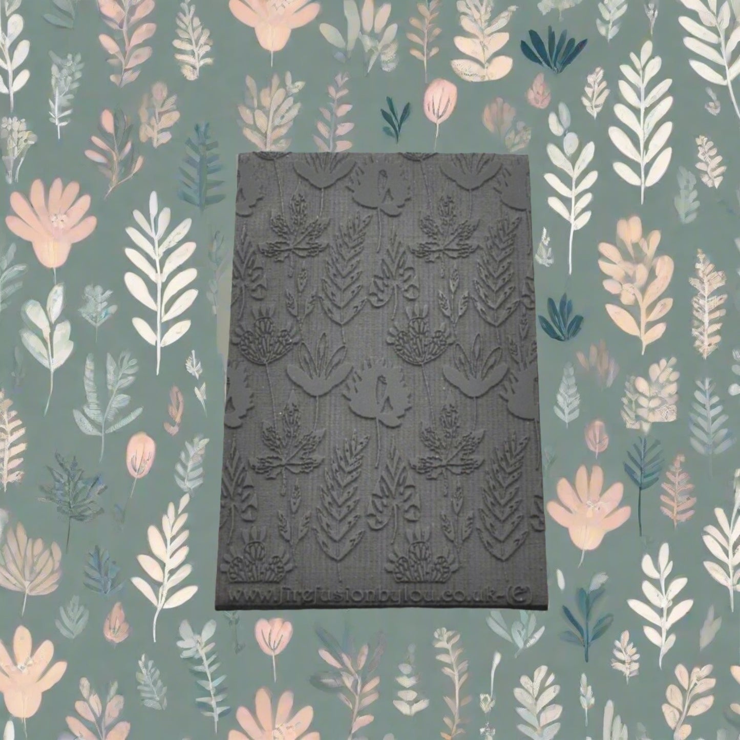 A 95 x 55 mm embossed texture mat with a flower design. Use to make a embossed impression on metal clay and polymer clay.