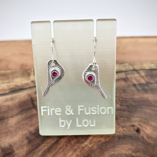 These 999 fine silver dangle earrings feature robin shapes complete with 925 sterling French hooks. Cubic zirconia stones in pink, blue, white, and purple adorn the wings.     Measuring 30mm/3cm in full length, including the earring wires, these  dangly Robins weigh 3.5 grams.