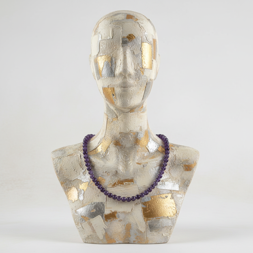 Mannequin bust with a purple necklace on a white background