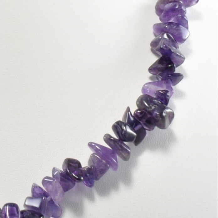 Necklace made of purple gemstone chips on a white background