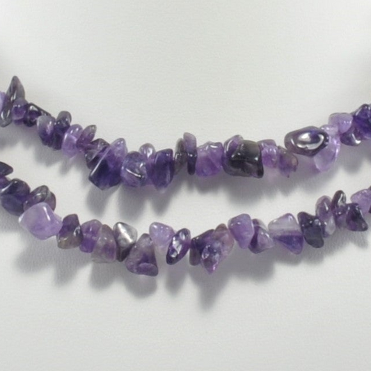 Necklace made of purple gemstone chips on a white background