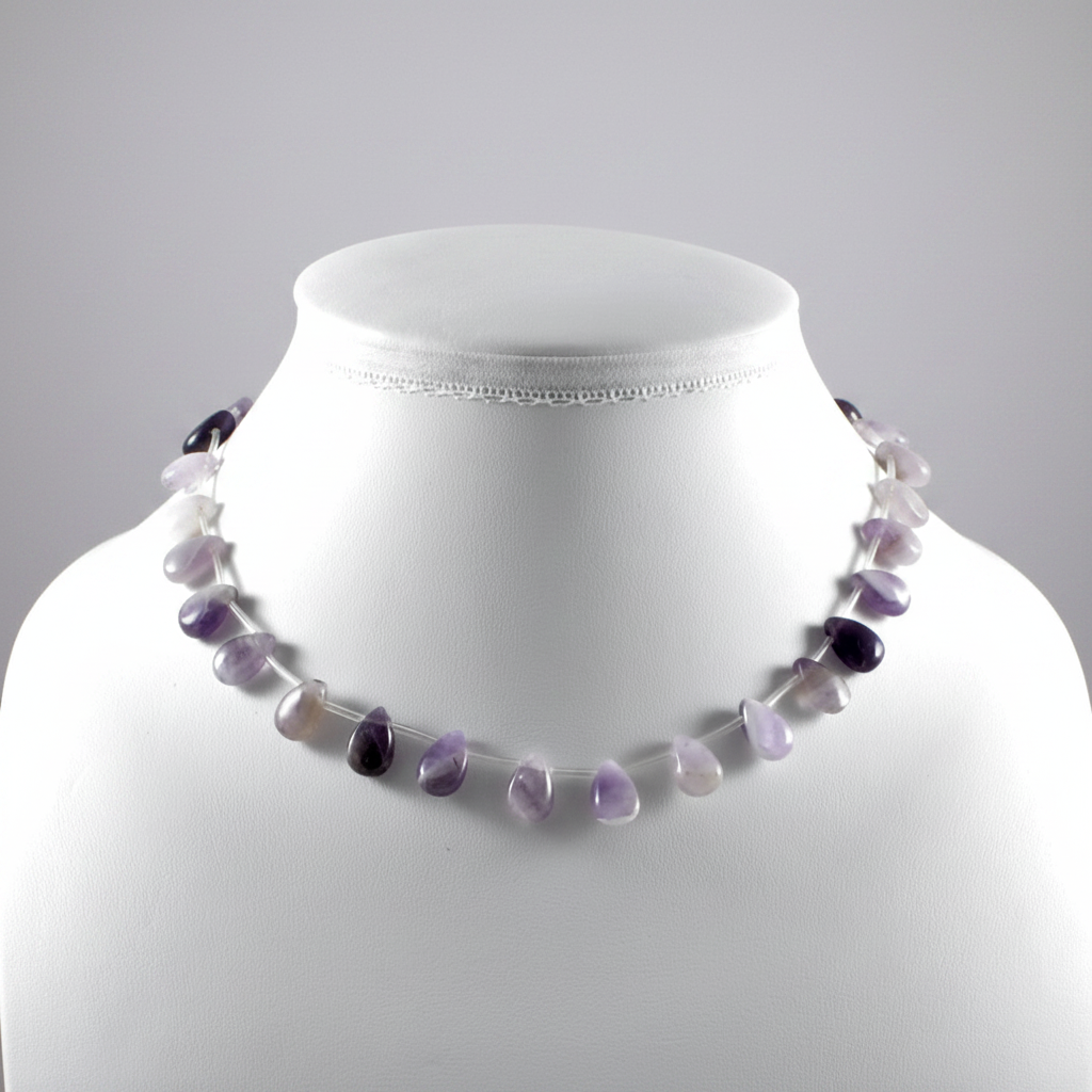 Necklace with purple and white beads on a mannequin against a gray background