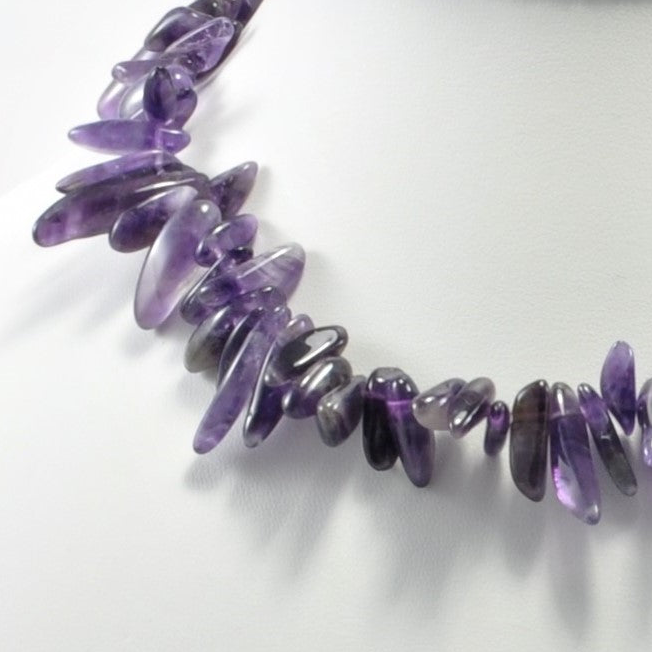 Necklace with purple beads on a white background