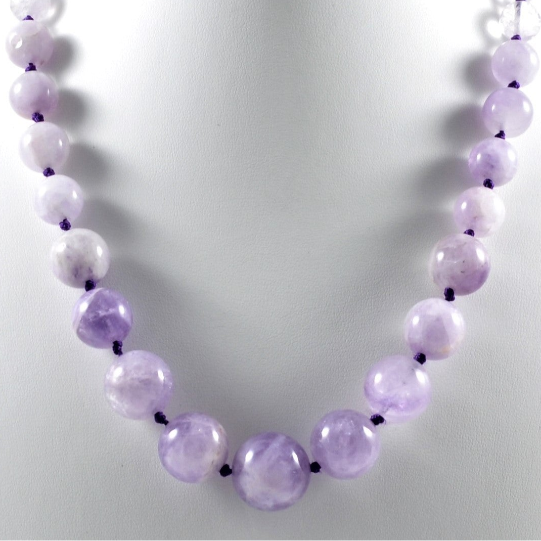 Necklace with purple beads on a light background