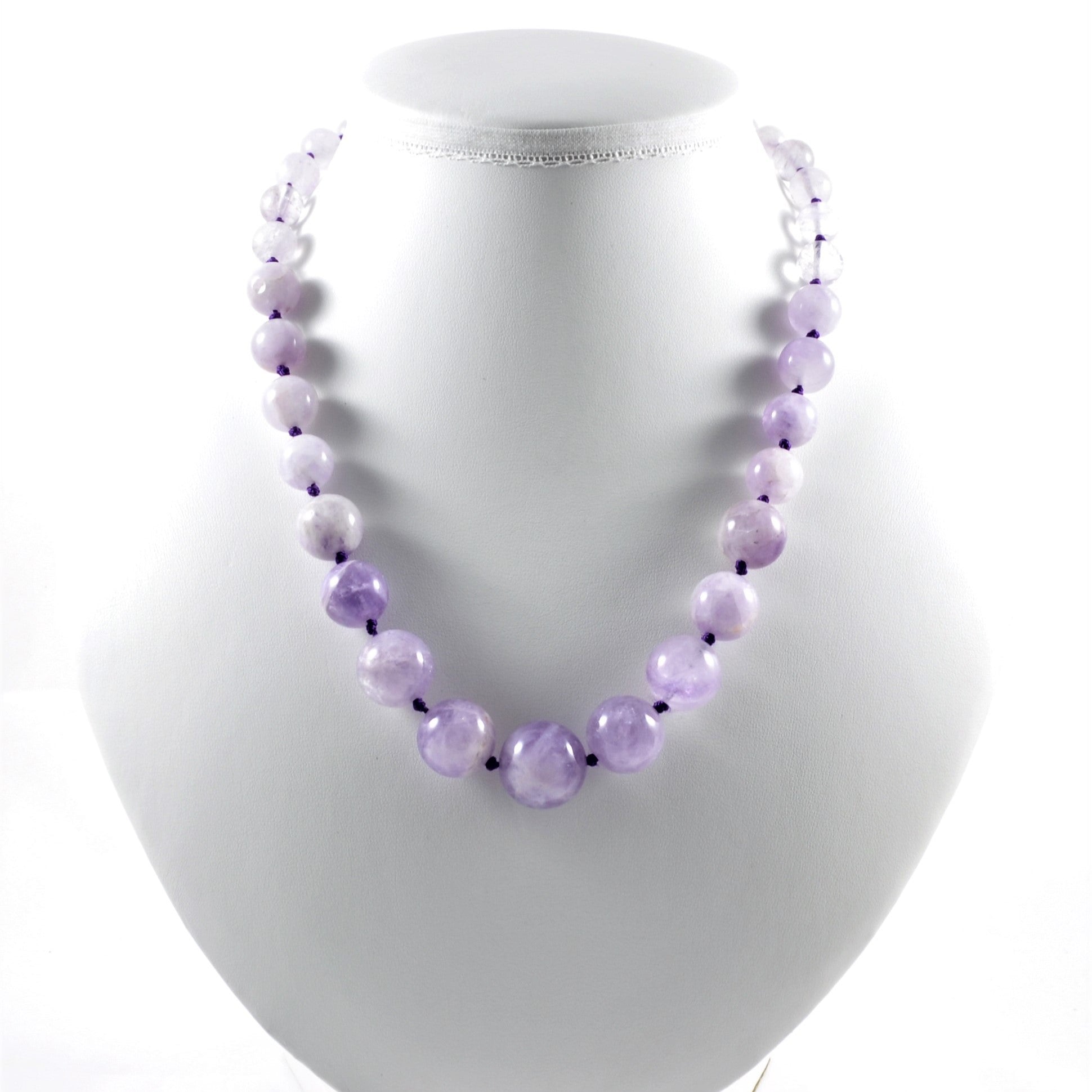 Necklace with purple beads on a white mannequin bust