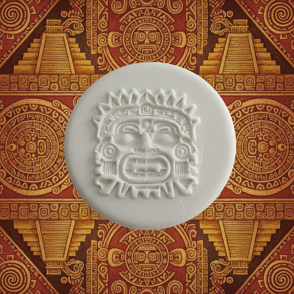 A round stamped clay featuring an embossed Aztec face design.