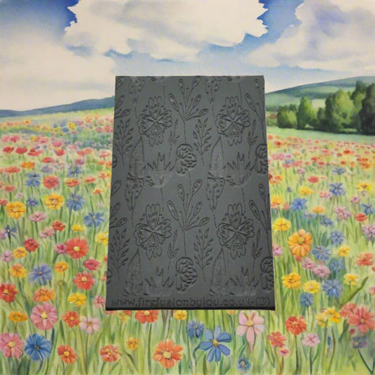 A 95 x 55 mm debossed texture mat with a flower design. Use to make a embossed impression on metal clay and polymer clay.