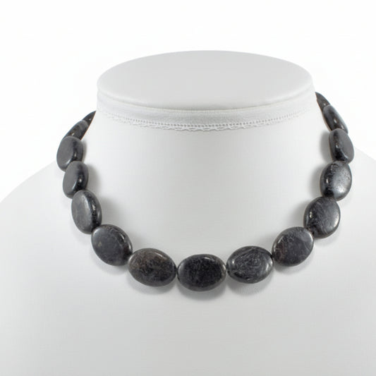  "Arfvedsonite oval beads 18x14mm with metallic shimmer on white background"