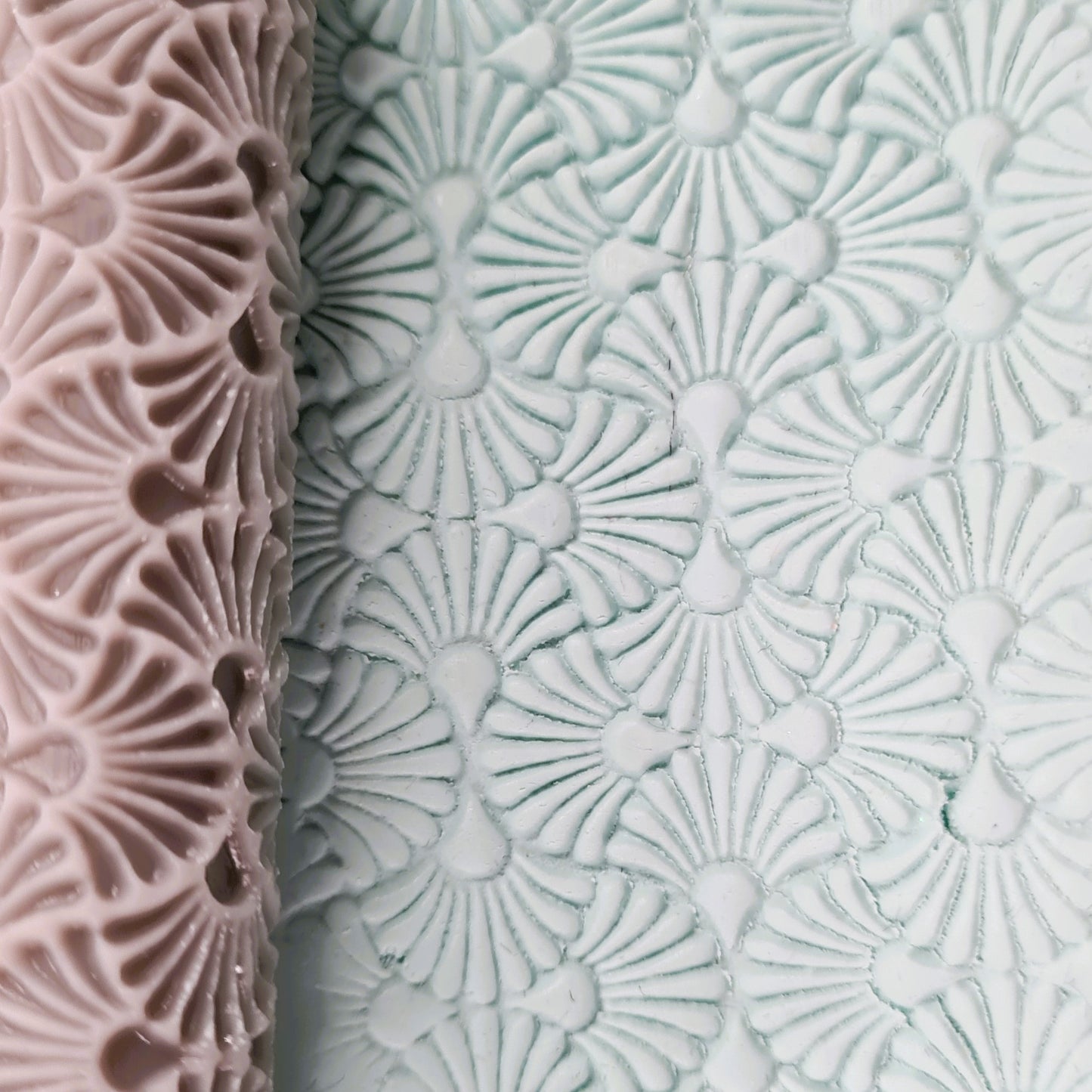 Textured roller one pink and one white clay with an art deco geometric pattern.