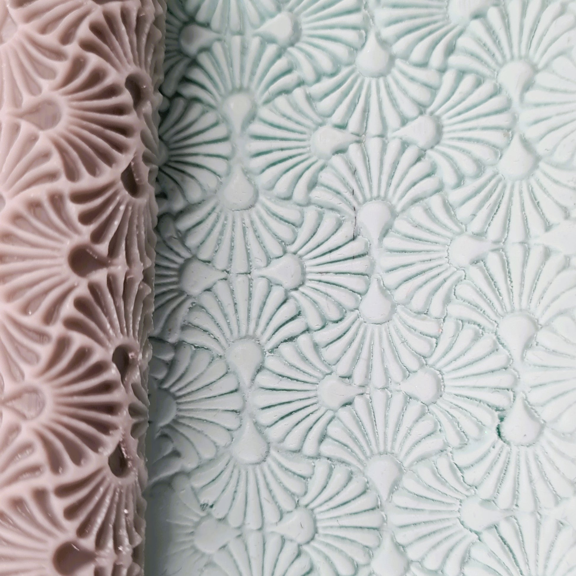 Textured roller one pink and one white clay with an art deco geometric pattern.